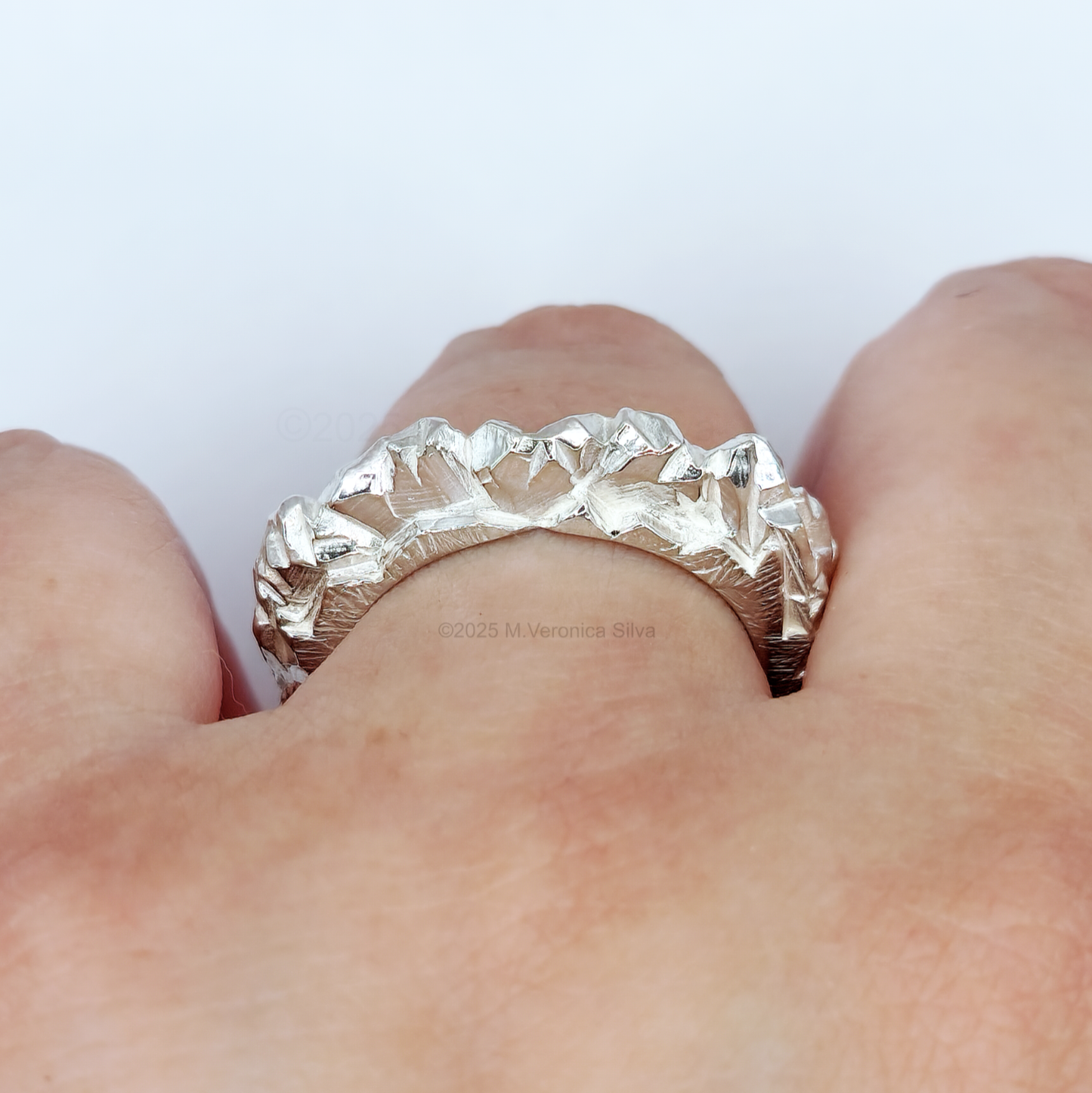 Unconformity silver statement ring on finger, detail