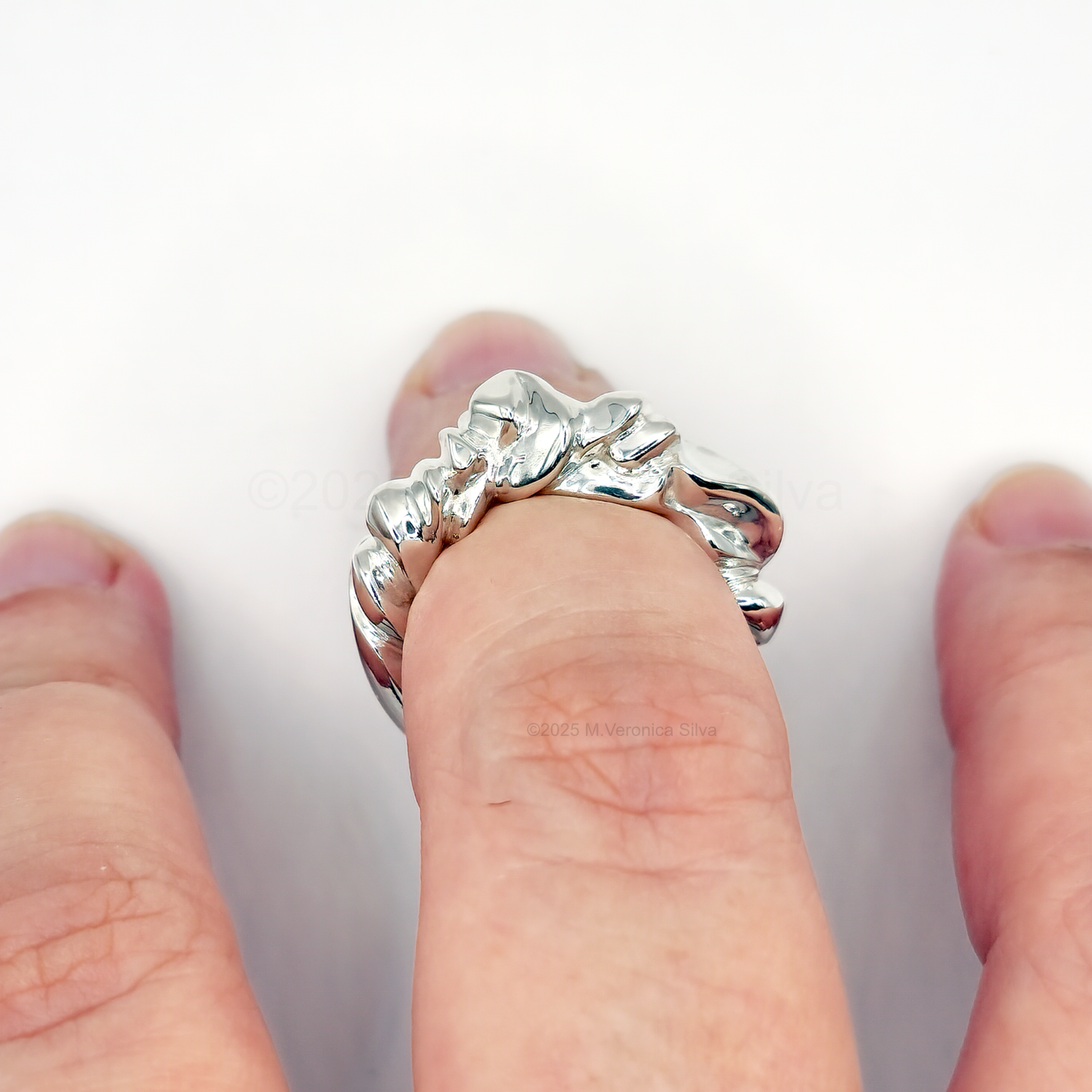 waterways and clouds silver statement ring on a hand